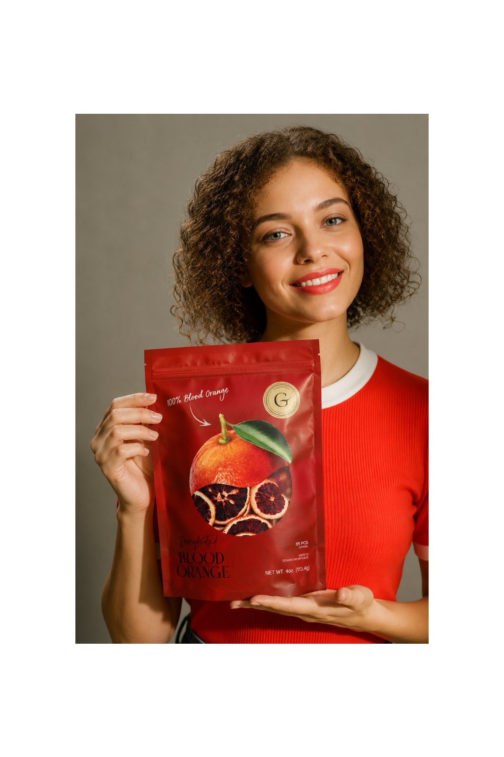 Woman holding dehydrated blood orange cocktail garnish for old fashioned, negroni and craft cocktails