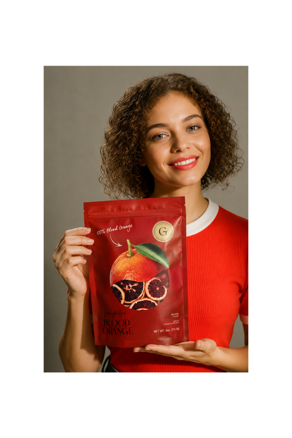 Woman holding dehydrated blood orange cocktail garnish for old fashioned, negroni and craft cocktails
