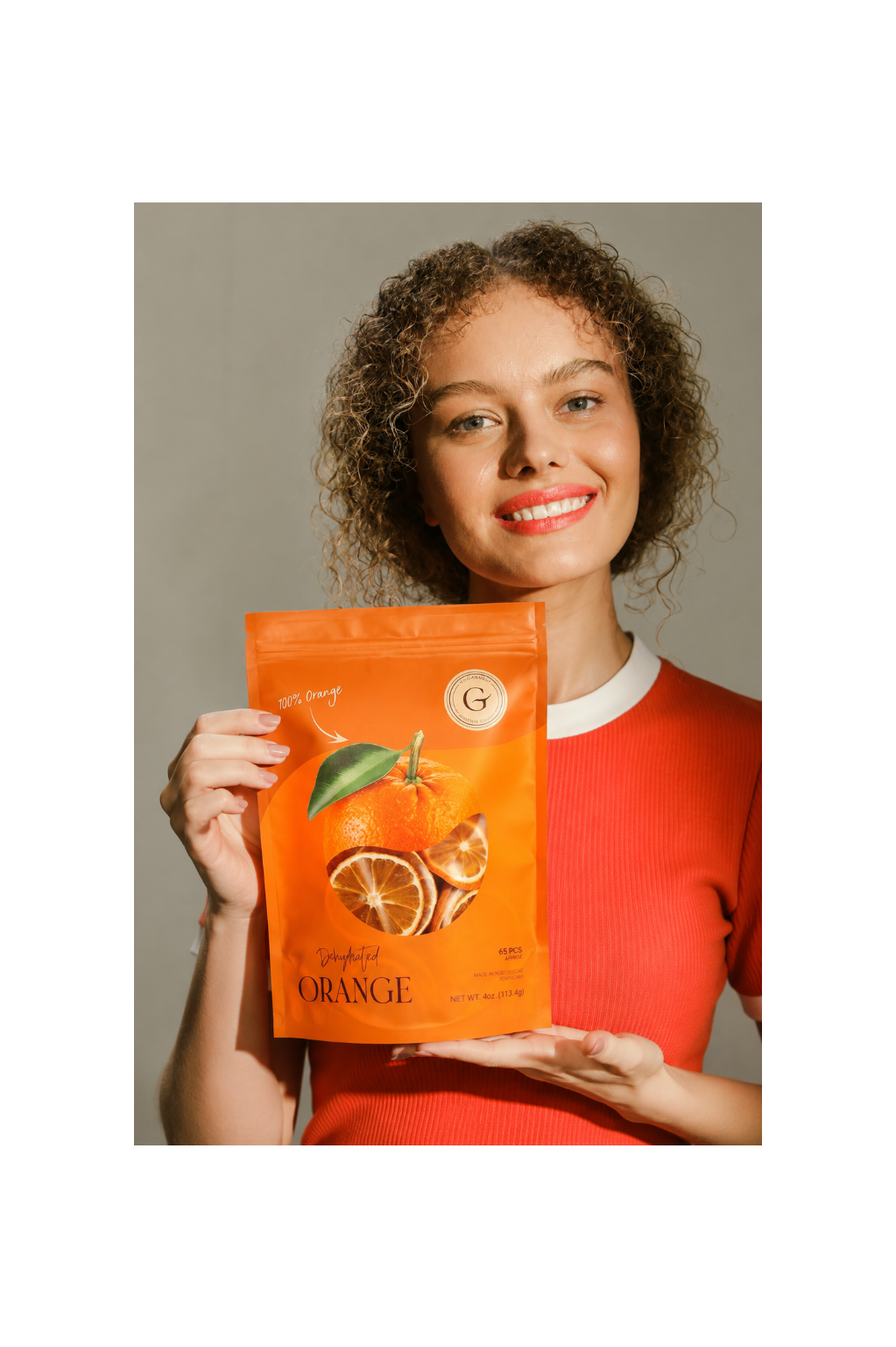 Woman holding dehydrated orange to cocktail garnish bag for old fashioned, whiskey and craft cocktails